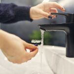 person rinsing clear aligners to clean invisalign clear aligners and care for clear aligners